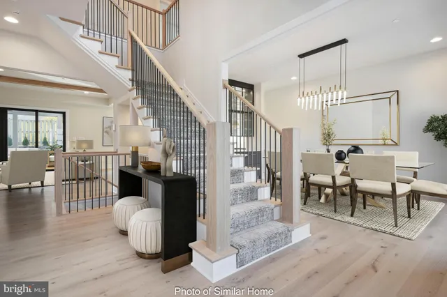 a living room with couches chairs and couches with wooden floor