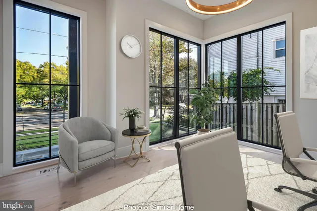a living room with furniture and a floor to ceiling window