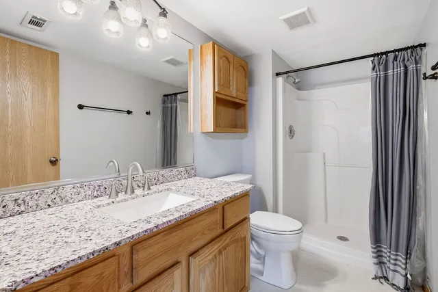 a bedroom with furniture and a chandelier