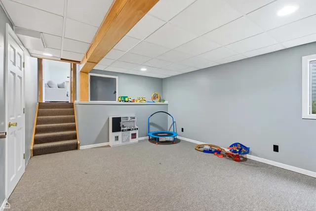 a view of backyard with outdoor seating and green space