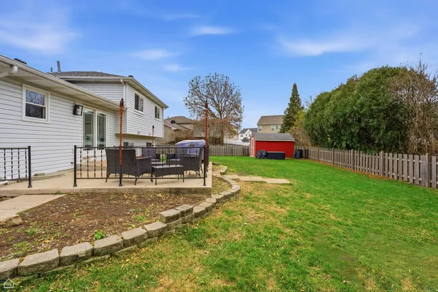 a backyard of a house with table and chairs