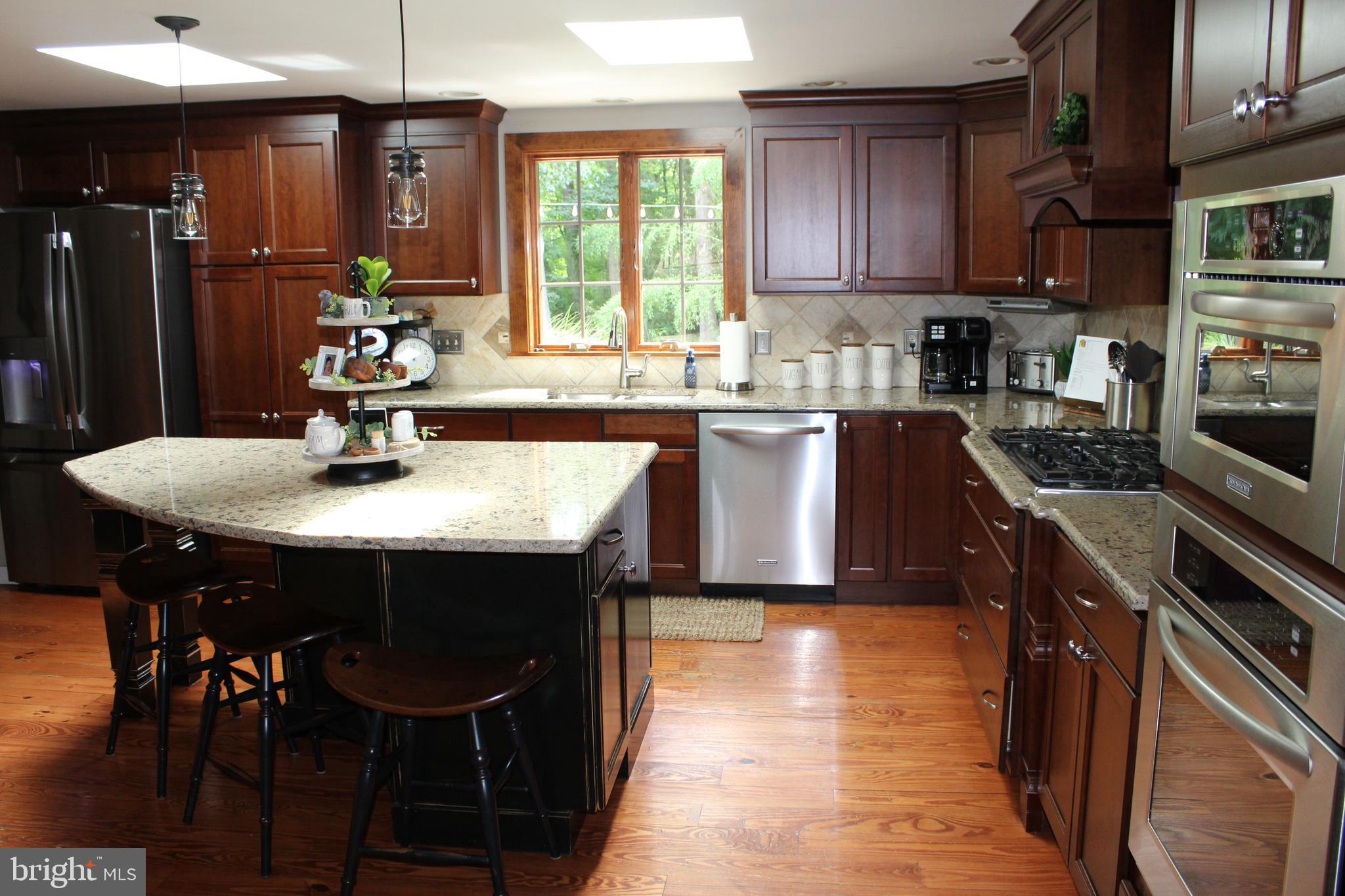 246 Acorn Lane Lititz, PA 17543 - Photo 85 of 120 a kitchen with stainless steel appliances granite countertop a sink a stove a table and chairs
