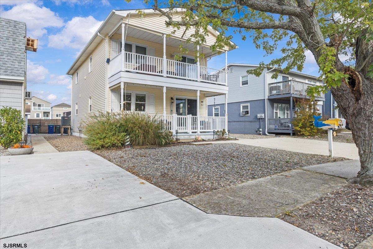 a front view of a residential apartment building with a yard