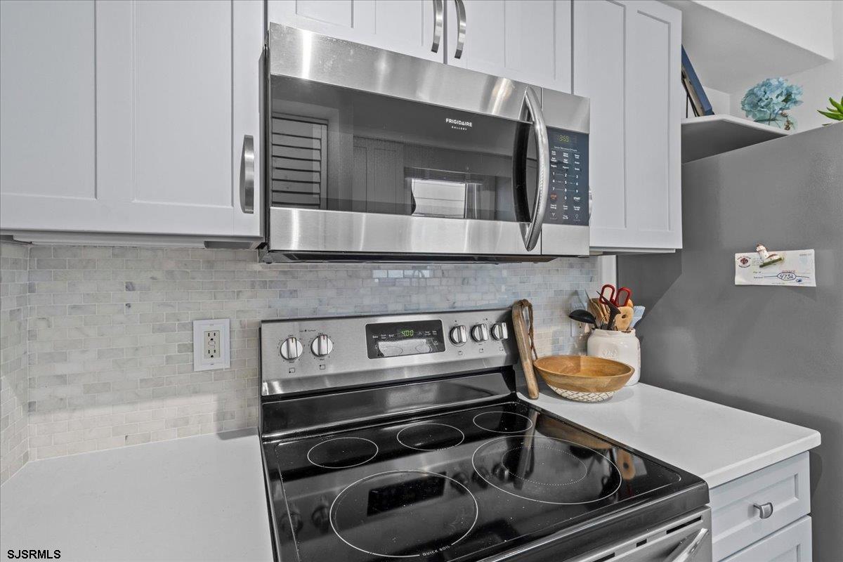 331 41st Street South, Unit 1 Brigantine, NJ 08203 - Photo 12 of 42 a kitchen with a stove and a microwave
