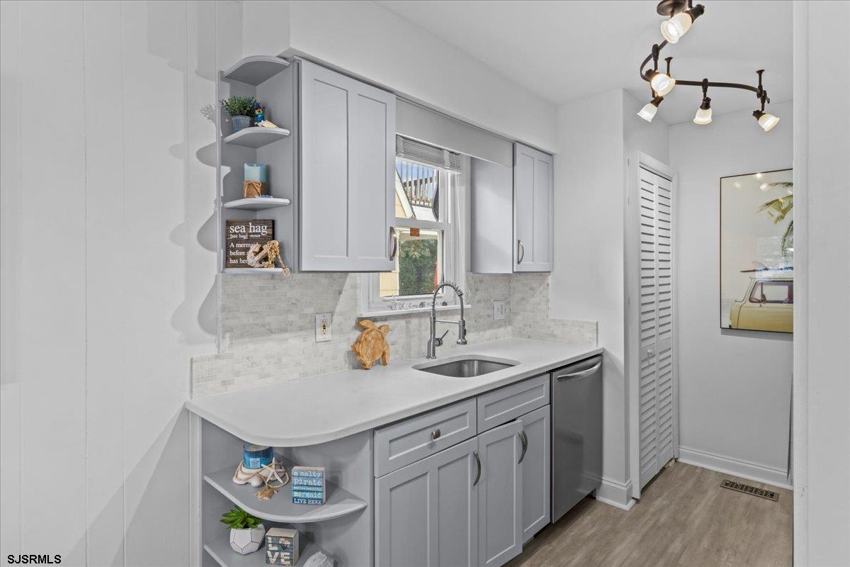 331 41st Street South, Unit 1 Brigantine, NJ 08203 - Photo 15 of 42 a kitchen with stainless steel appliances a sink and a refrigerator