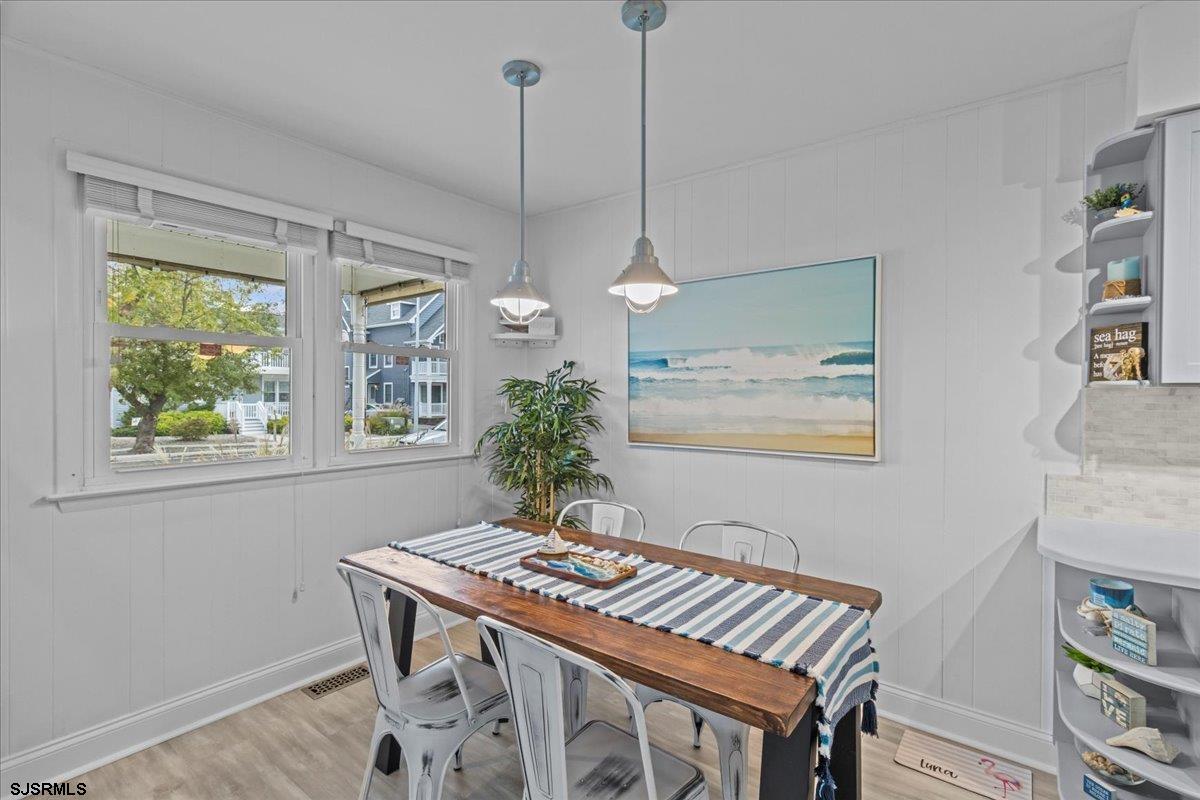 331 41st Street South, Unit 1 Brigantine, NJ 08203 - Photo 16 of 42 a view of a dining room with furniture window and wooden floor