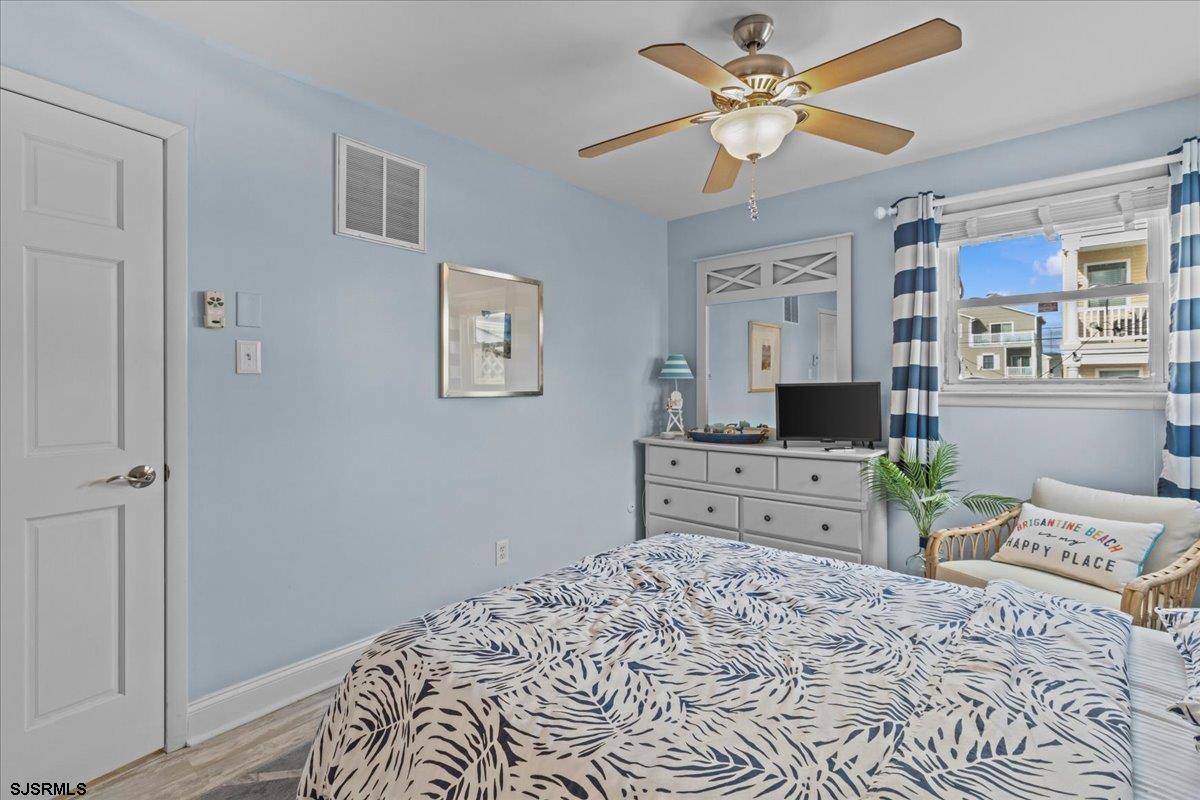 331 41st Street South, Unit 1 Brigantine, NJ 08203 - Photo 21 of 42 a bedroom with a bed dresser and a window