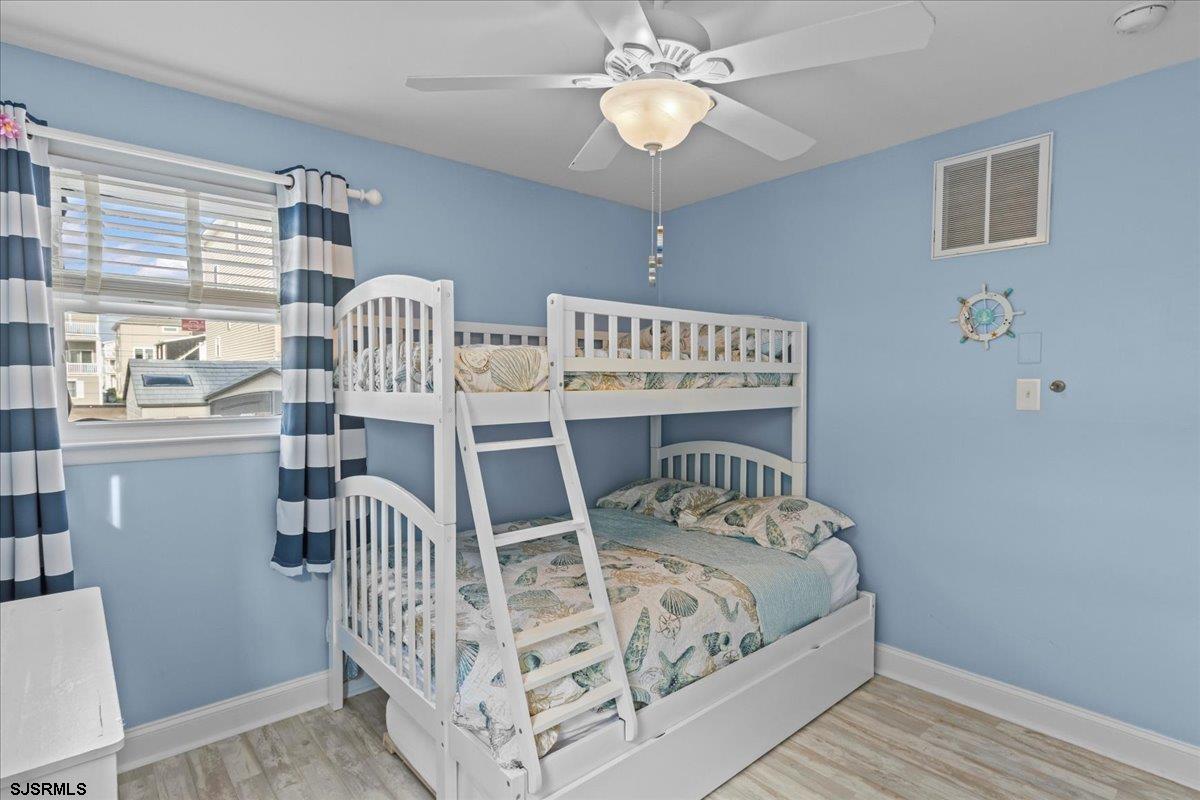 331 41st Street South, Unit 1 Brigantine, NJ 08203 - Photo 25 of 42 a bed sitting in a bedroom next to a window