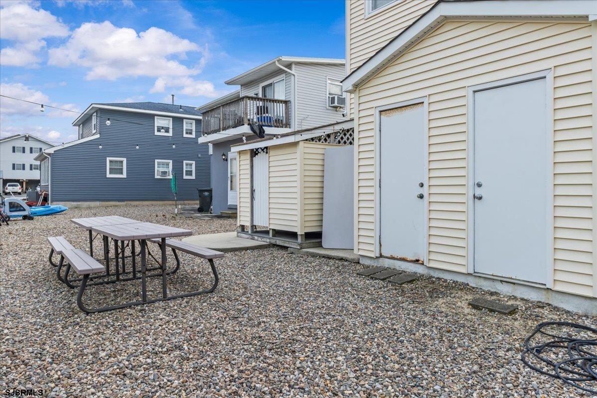 331 41st Street South, Unit 1 Brigantine, NJ 08203 - Photo 29 of 42 a view of a white house with many windows next to yard