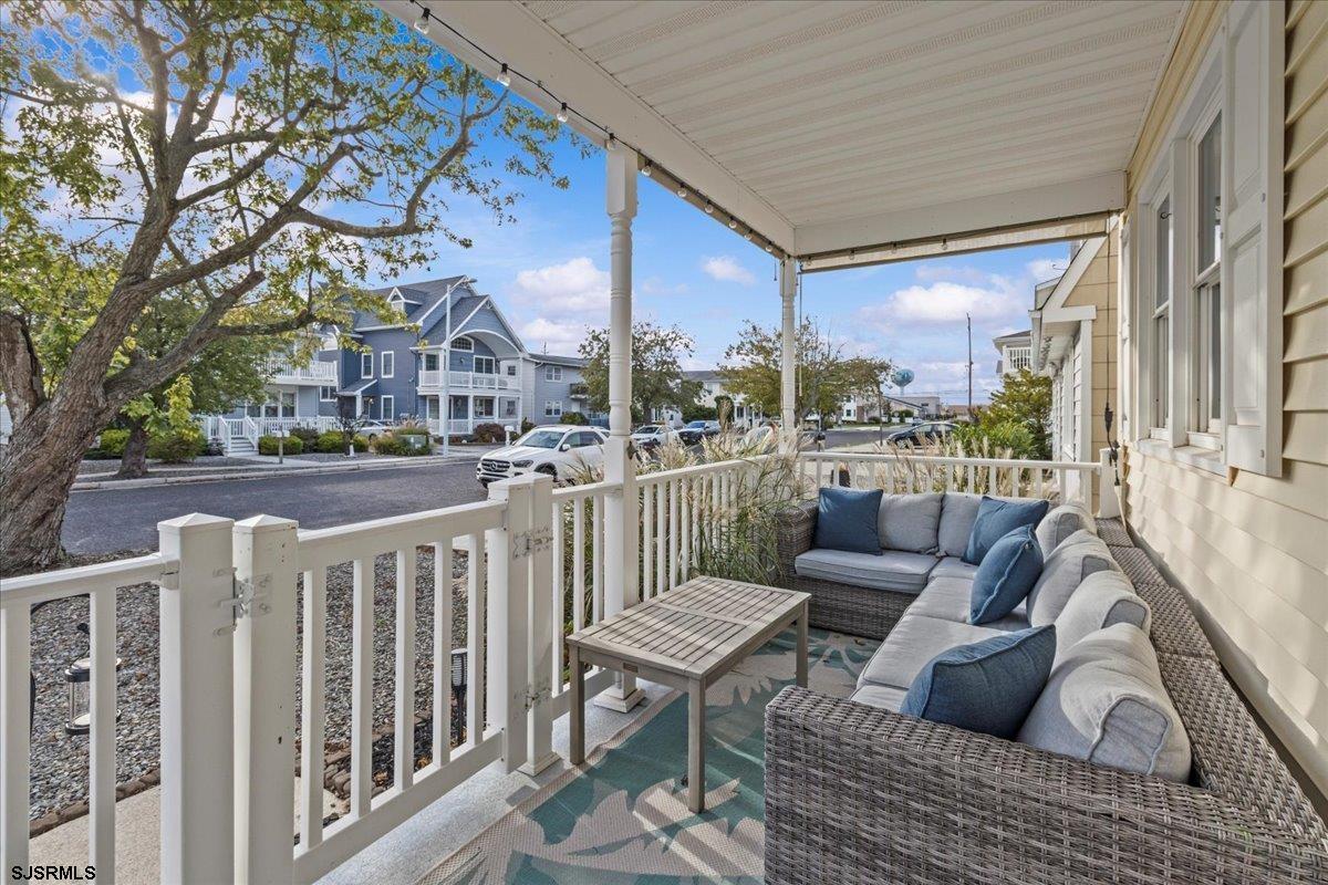 331 41st Street South, Unit 1 Brigantine, NJ 08203 - Photo 5 of 42 a view of a patio with couches chairs and a wooden floor