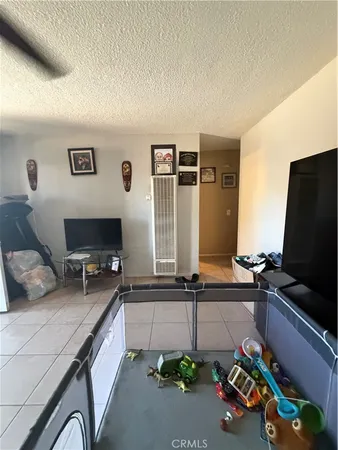 a bedroom with furniture and a flat screen tv