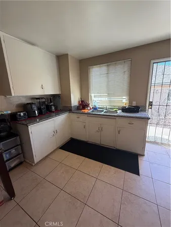 a kitchen with a sink a stove and cabinets