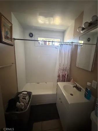 a bathroom with a sink a bathtub and shower