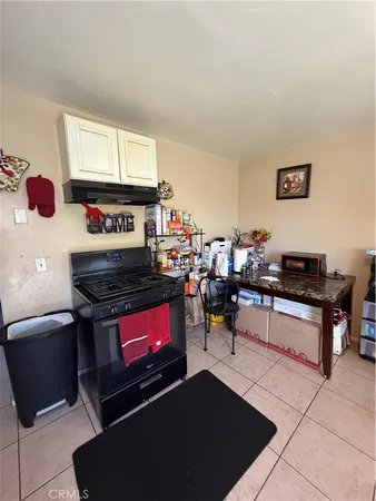 a room with fireplace furniture and a rug