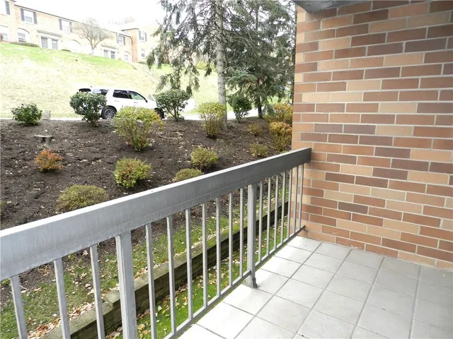 a view of a balcony with trees
