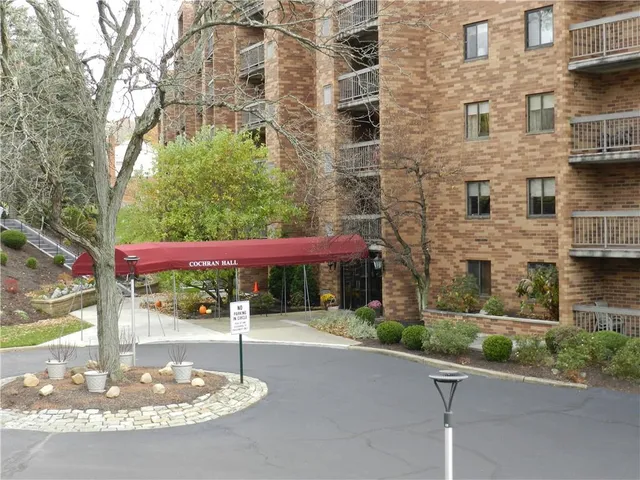 a view of a brick building with a yard in front of it