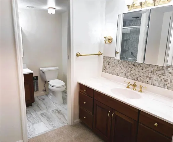 a bathroom with a shower sink and mirror