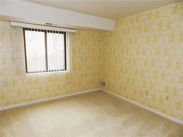 a room with pool table and a wooden floor