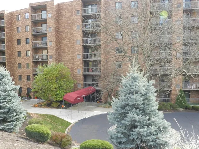 a view of a backyard with table and chairs under an umbrella