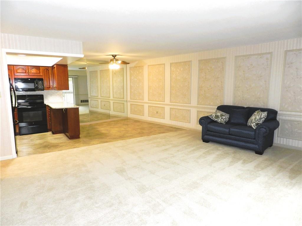 1500 Cochran Road, Unit 512 Pittsburgh, PA 15243 - Photo 10 of 39 This spacious open living, dining and kitchen area is fabulous ! NEW carpet and so light and bright with the sliding door access to the large balcony.