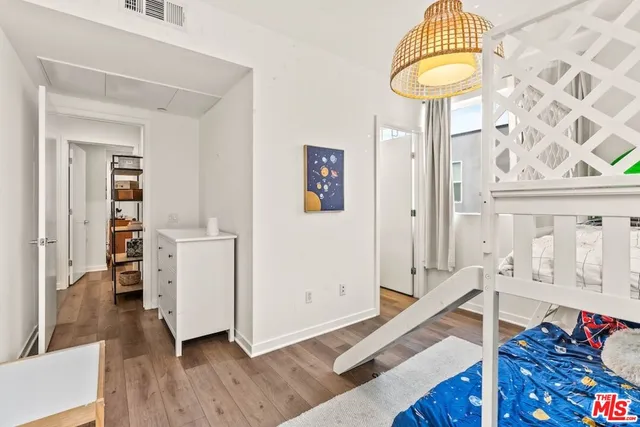 a view of hall way with furniture and wooden floor