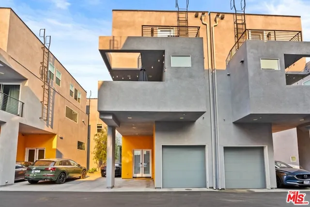 a couple of cars parked in front of a building