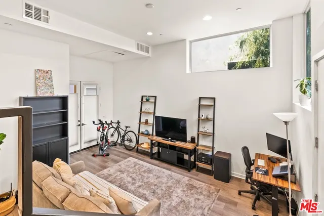 a bedroom with furniture and a flat screen tv