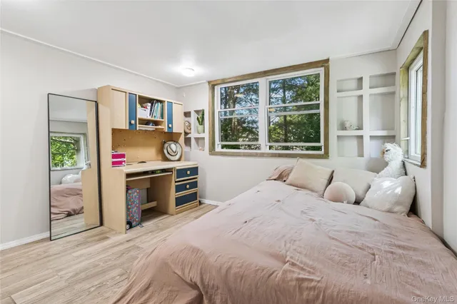 a bedroom with a bed and a large window