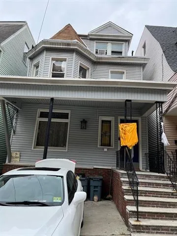 a view of building with a car parked front door
