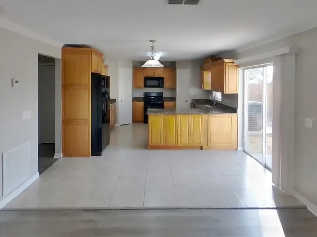 a kitchen with a refrigerator and a sink