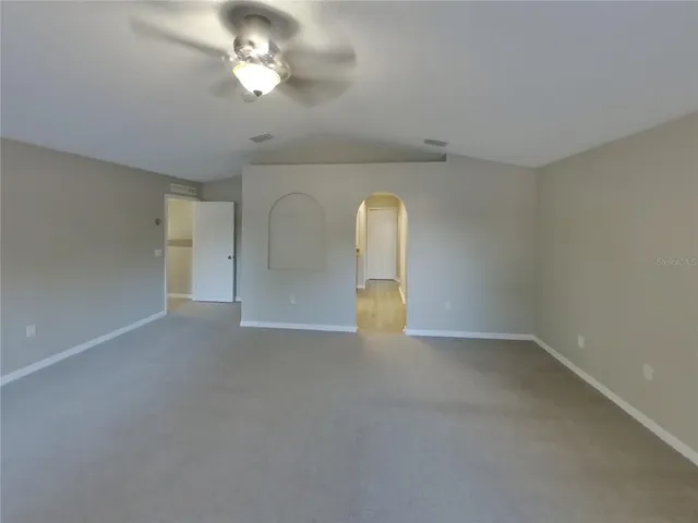 an empty room with a empty space and a ceiling fan