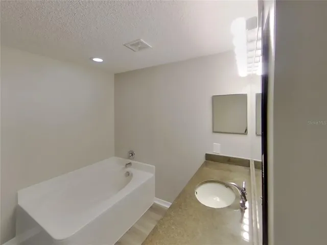 a bathroom with a tub and a toilet
