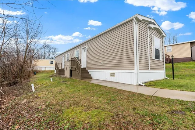 a view of a house with backyard and white walls
