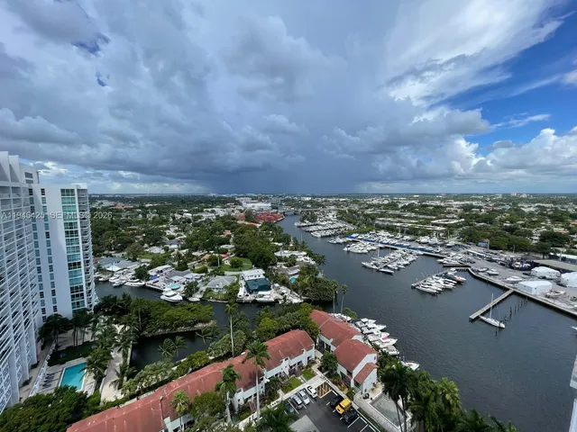 an aerial view of lake and residential houses with outdoor space