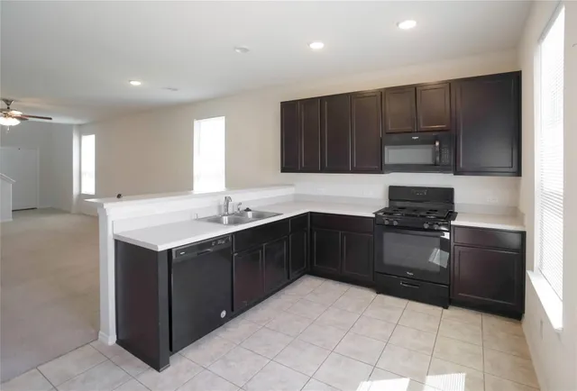 a view of room with a ceiling fan and window