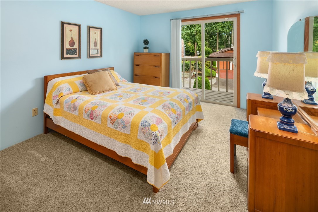 16433 Southeast 149th Street Renton, WA 98059 - Photo 16 of 22 a bed sitting in a bedroom next to a window