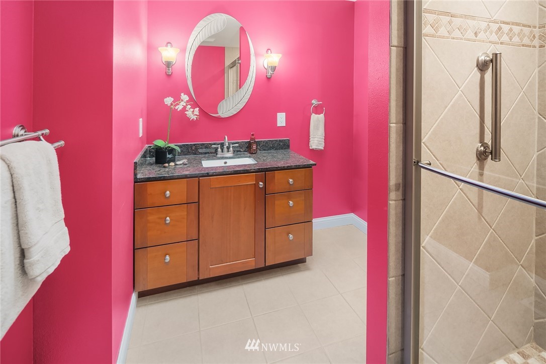 16433 Southeast 149th Street Renton, WA 98059 - Photo 17 of 22 a bathroom with a sink mirror and vanity