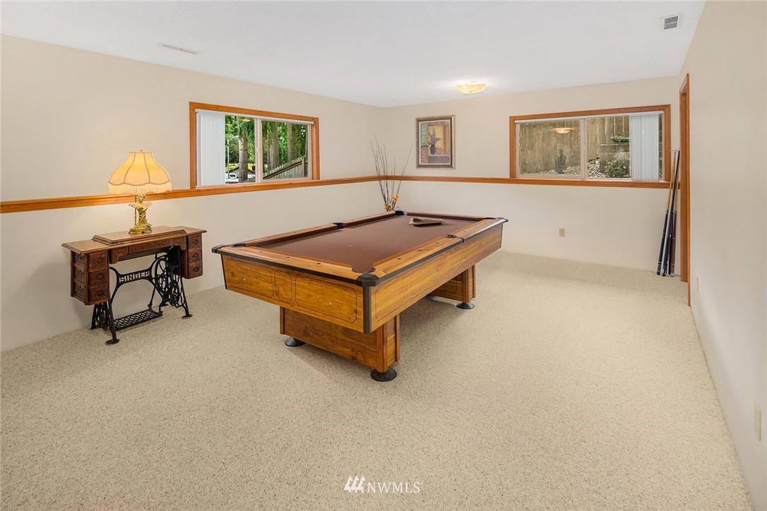 16433 Southeast 149th Street Renton, WA 98059 - Photo 21 of 22 a living room with furniture and paintings on the wall