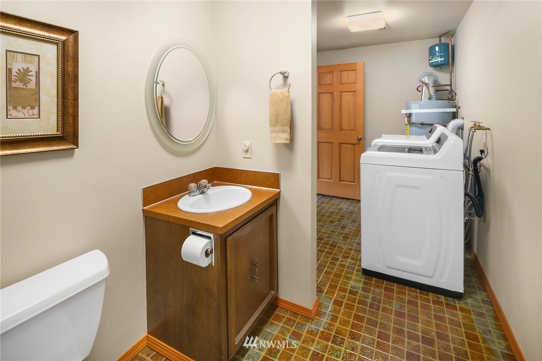 16433 Southeast 149th Street Renton, WA 98059 - Photo 22 of 22 a room with a washing machine and a mirror