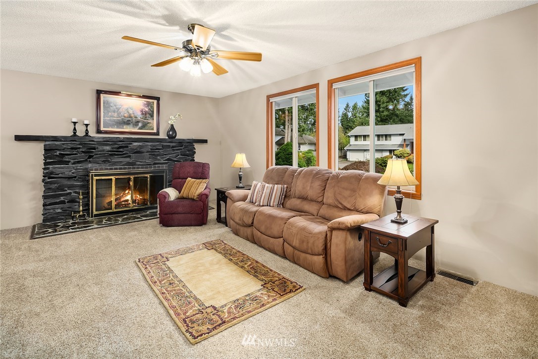 16433 Southeast 149th Street Renton, WA 98059 - Photo 4 of 22 a living room with furniture and a fireplace