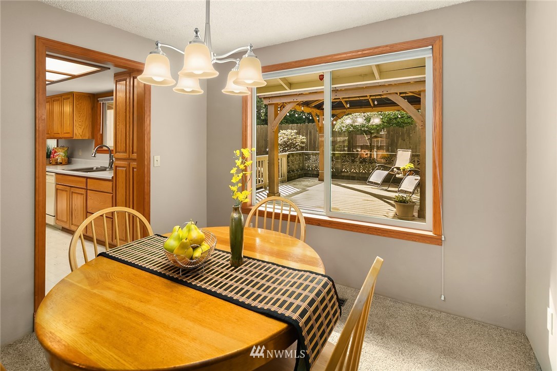 16433 Southeast 149th Street Renton, WA 98059 - Photo 6 of 22 a view of a dining room with furniture wooden floor and a chandelier