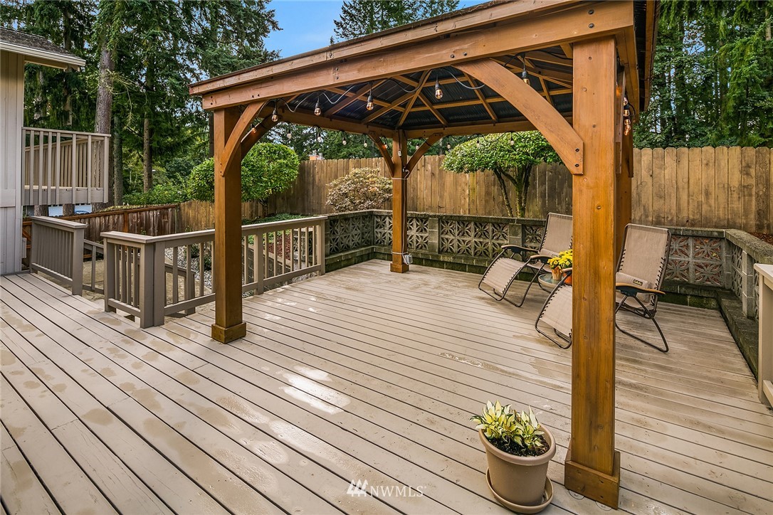 16433 Southeast 149th Street Renton, WA 98059 - Photo 10 of 22 a view of deck with table and chairs potted plants with wooden floor and fence