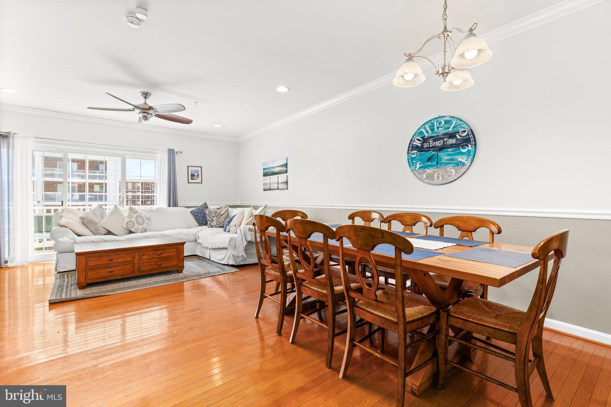 617 Salt Spray Road, Unit B Ocean City, MD 21842 - Photo 45 of 72 a view of a dining room with furniture wooden floor and a chandelier