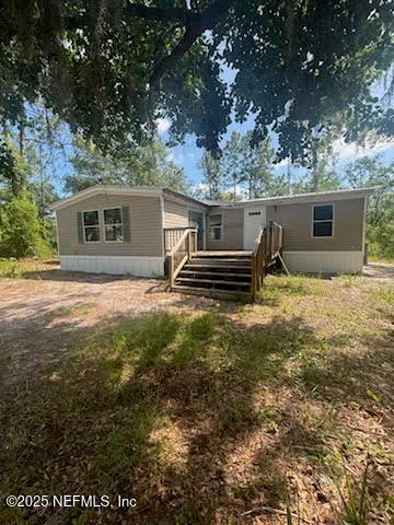 a backyard of a house with yard and outdoor seating