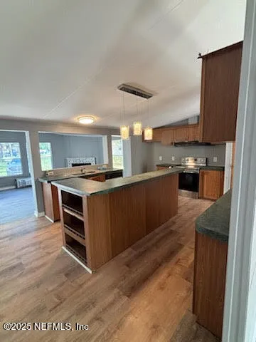 a kitchen with stainless steel appliances granite countertop a stove a sink and a refrigerator