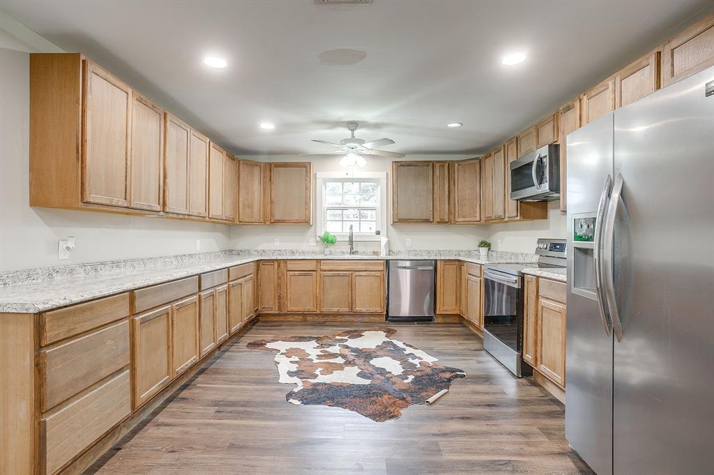 6260 Silver Creek Azle Road Azle, TX 76020 - Photo 2 of 40 a kitchen with granite countertop stainless steel appliances cabinets a sink and a counter top space