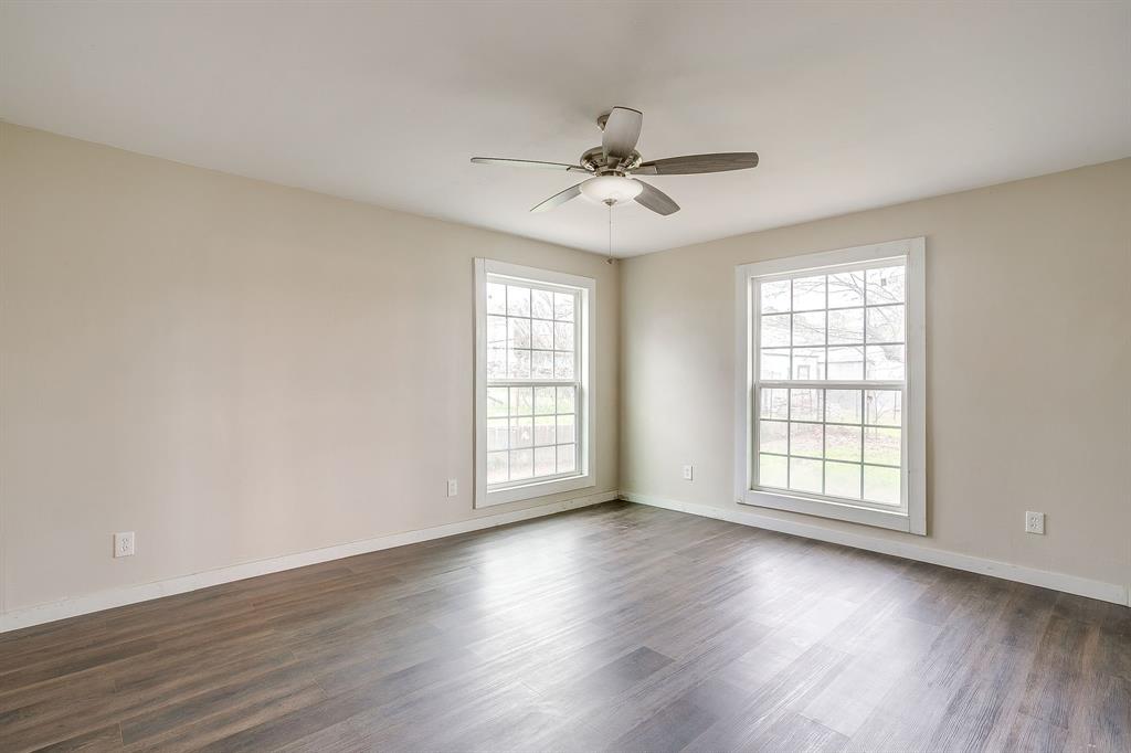6260 Silver Creek Azle Road Azle, TX 76020 - Photo 24 of 40 a view of an empty room with wooden floor and a window