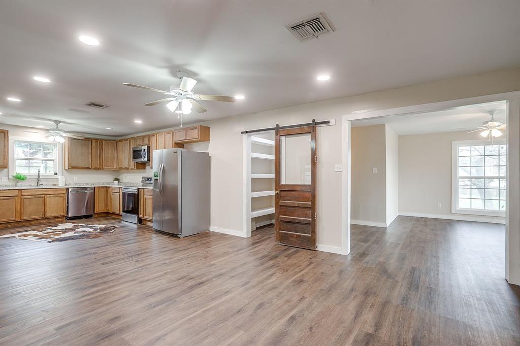 6260 Silver Creek Azle Road Azle, TX 76020 - Photo 4 of 40 a view of a kitchen with stainless steel appliances refrigerator cabinets and wooden floor