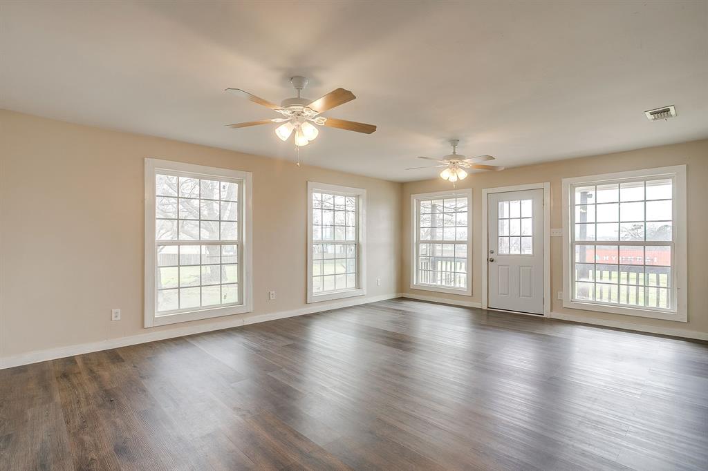 6260 Silver Creek Azle Road Azle, TX 76020 - Photo 5 of 40 a view of an empty room with wooden floor and a window