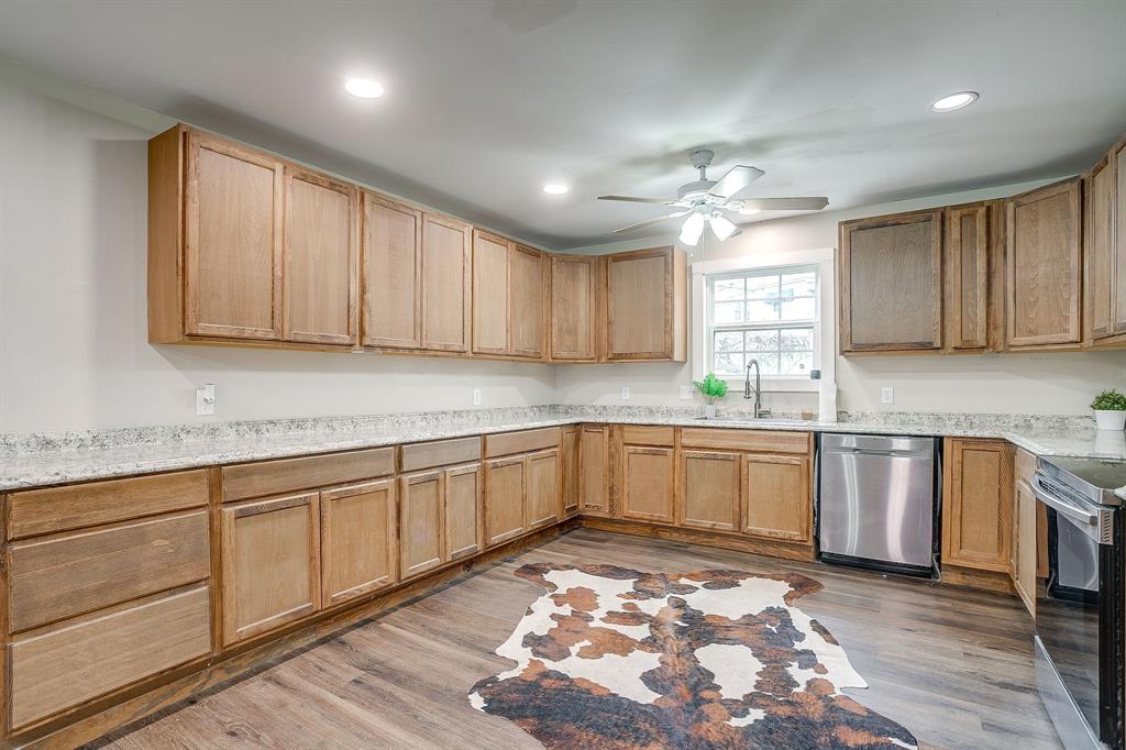 6260 Silver Creek Azle Road Azle, TX 76020 - Photo 7 of 40 a kitchen with stainless steel appliances granite countertop a sink stove and cabinets